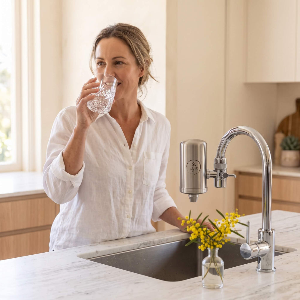 Drinking a glass of filtered water from the HolyH₂O Tap Mate